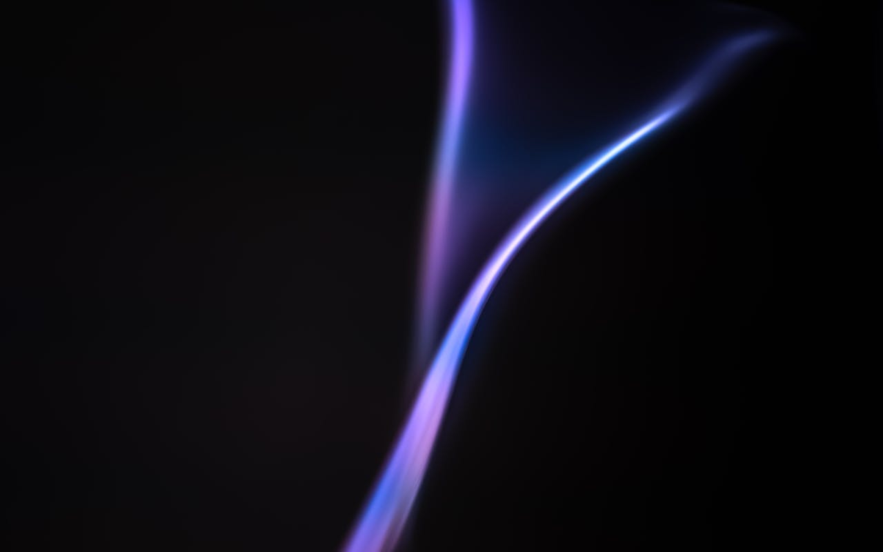 services-03 Vibrant abstract gradient resembling a flame against a dark backdrop, showcasing smooth color transitions.